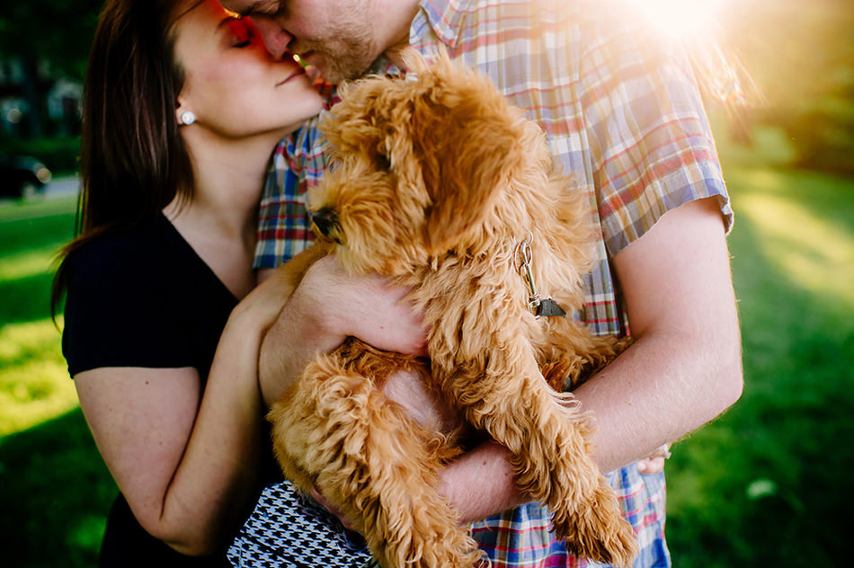 Sweet golden doodle cuddles with moma nd dad durin gtheir engagement shoot.