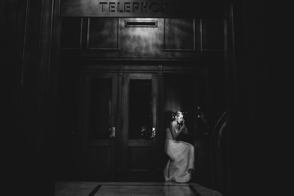 moody bridal portrait in old telephone booth