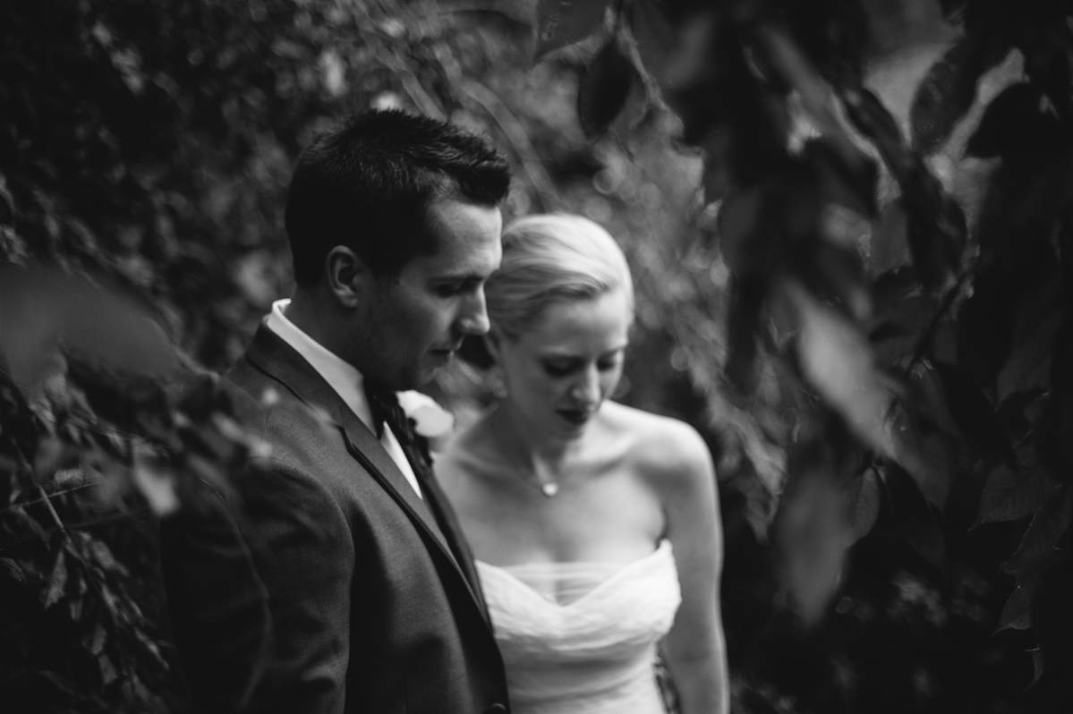 moody black and white photo of bride and groom