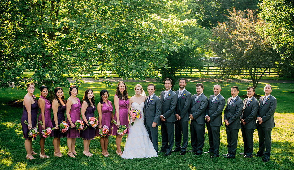 wedding party seven groomsment seven bridesmaids purple dresses