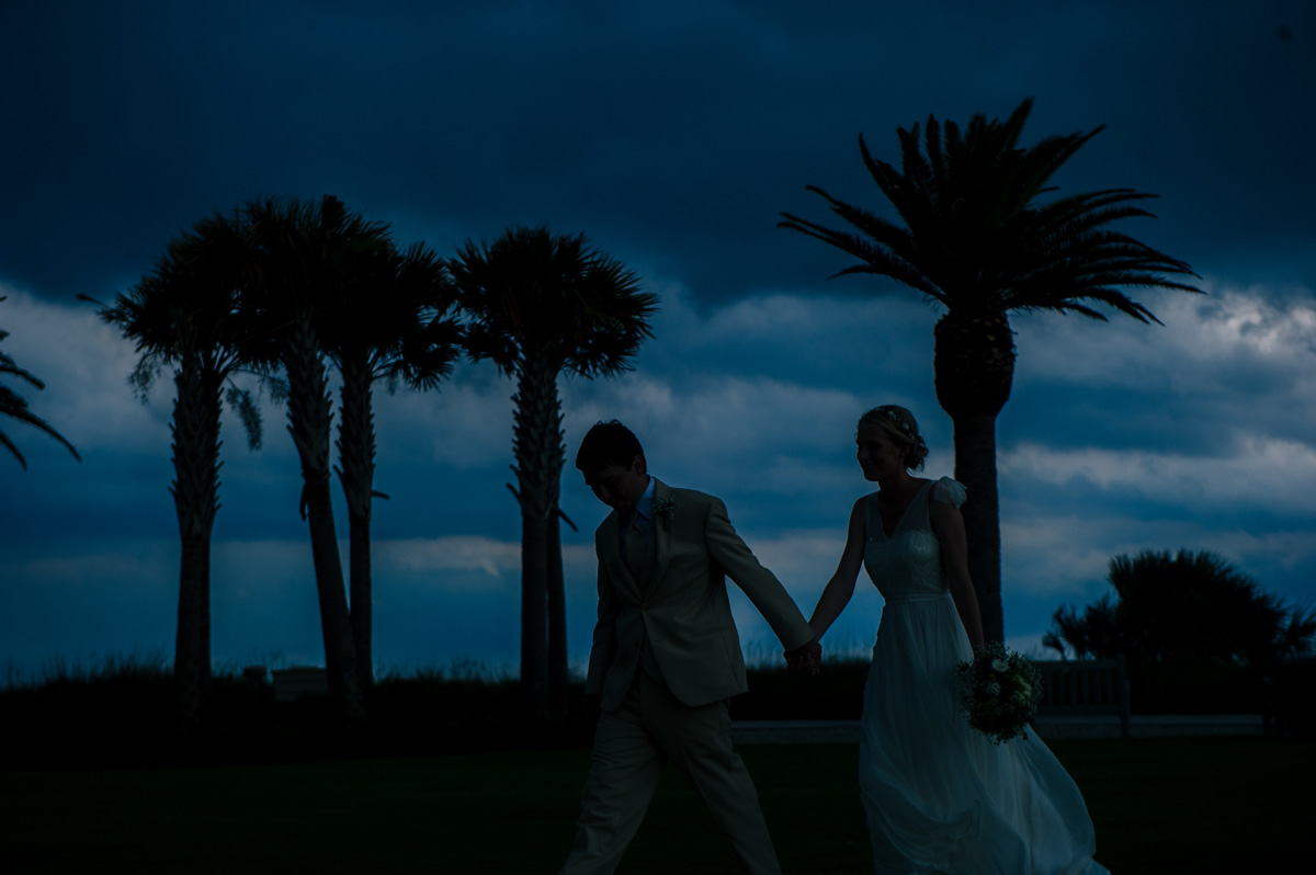 newlyweds running from storm clouds