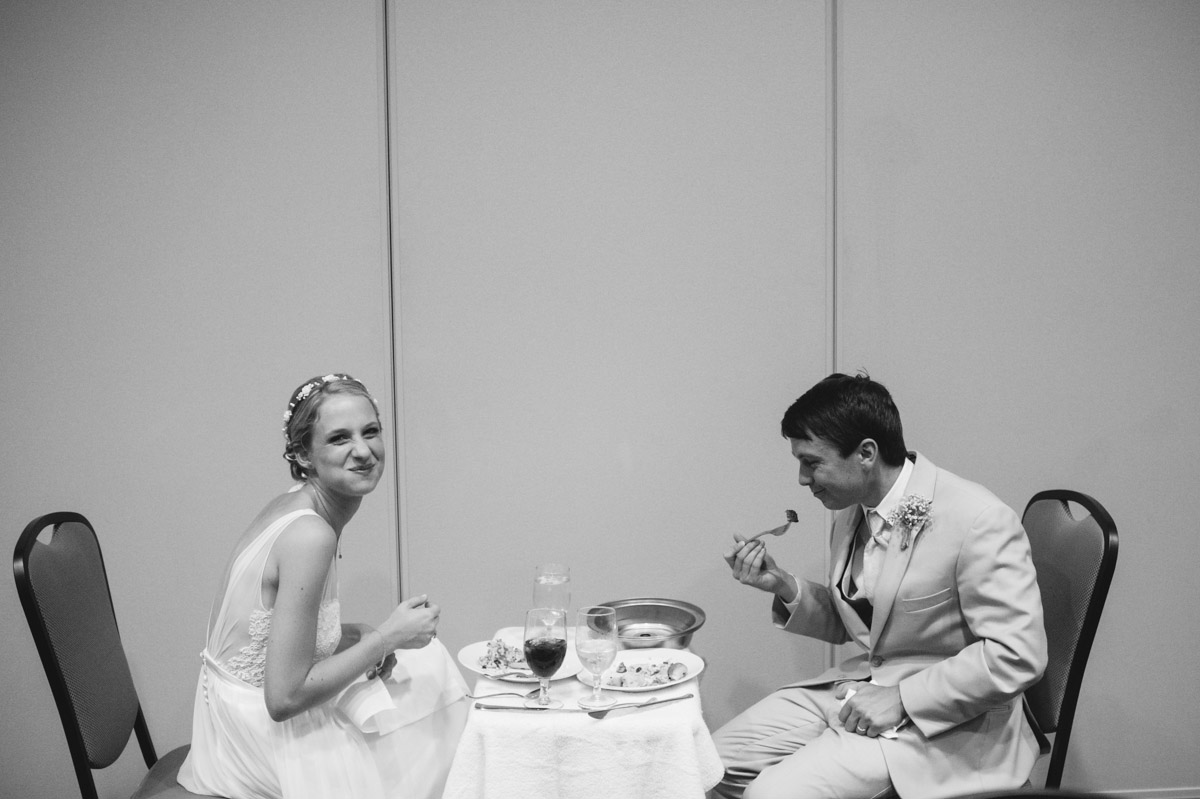 candid photo of bride and groom eating dinner