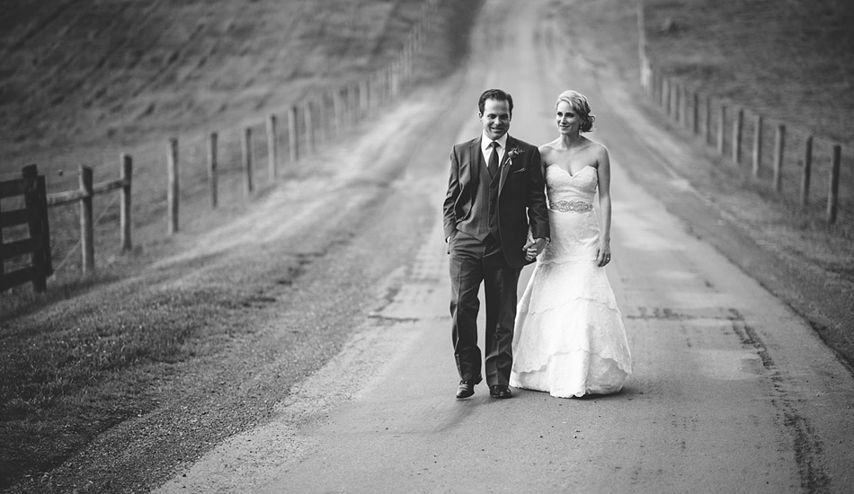 bride and groom walking down road wedding portrait