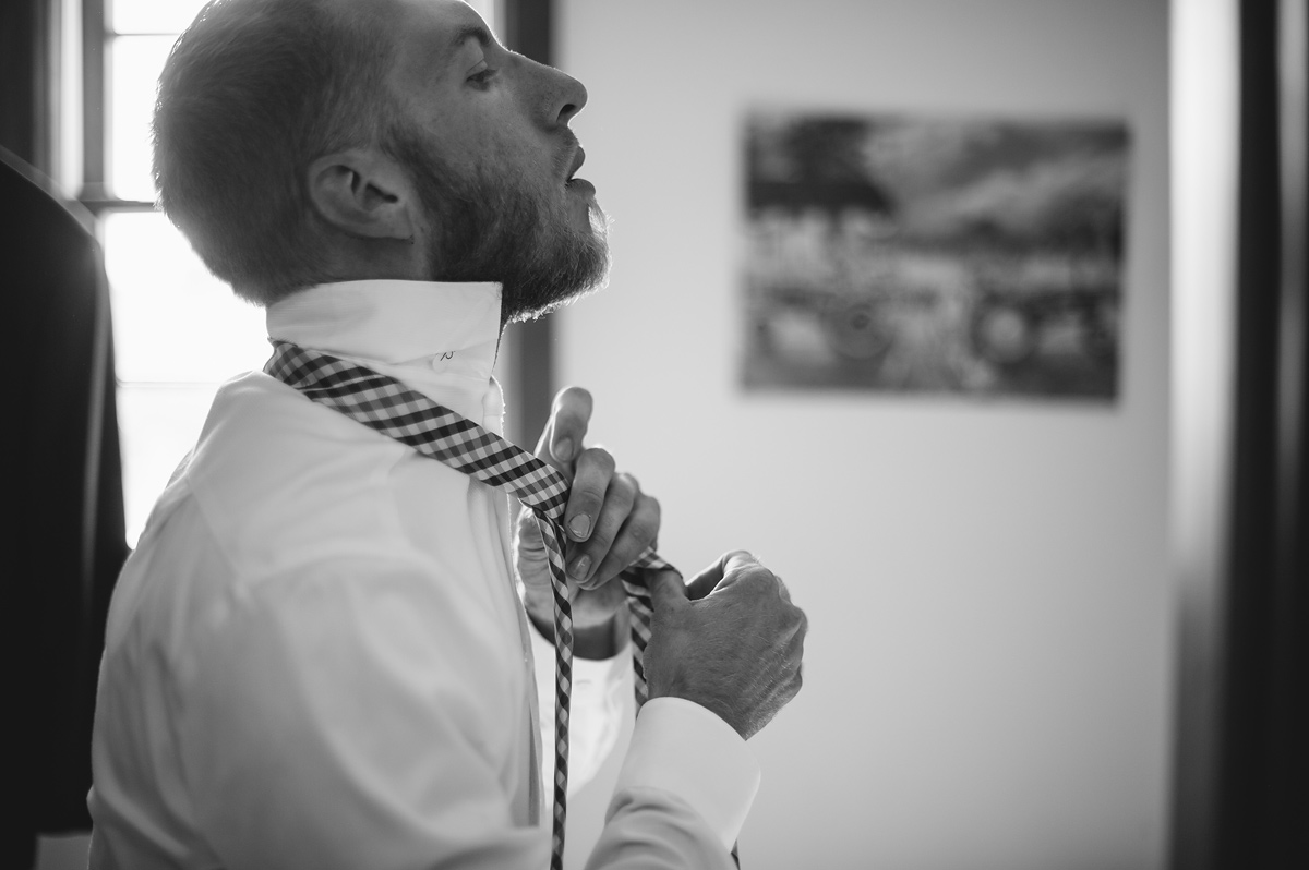 groom tying tie