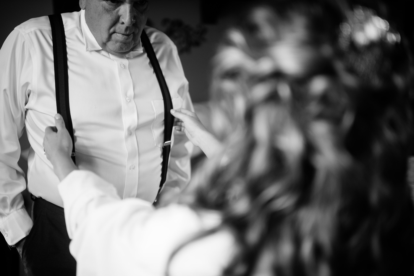 bride helping dad with suspenders