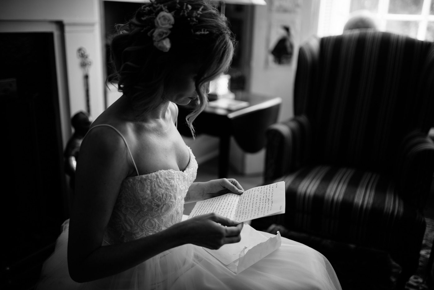 bride reading letter on her wedding day