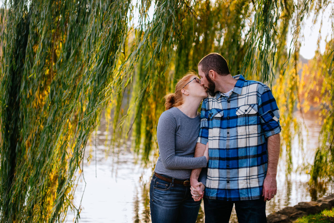 couple kissing under willow tree in wv