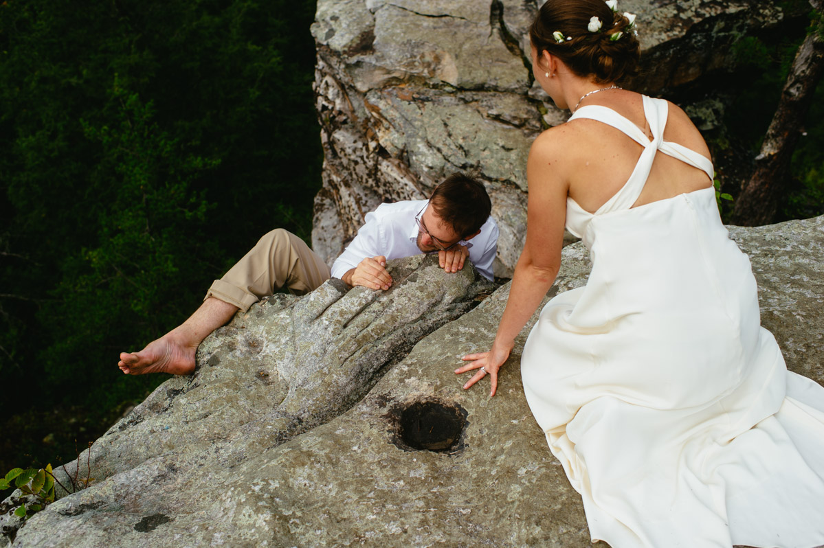 groom climbing rock during wedding new river gorge fayetteville photographers the oberports