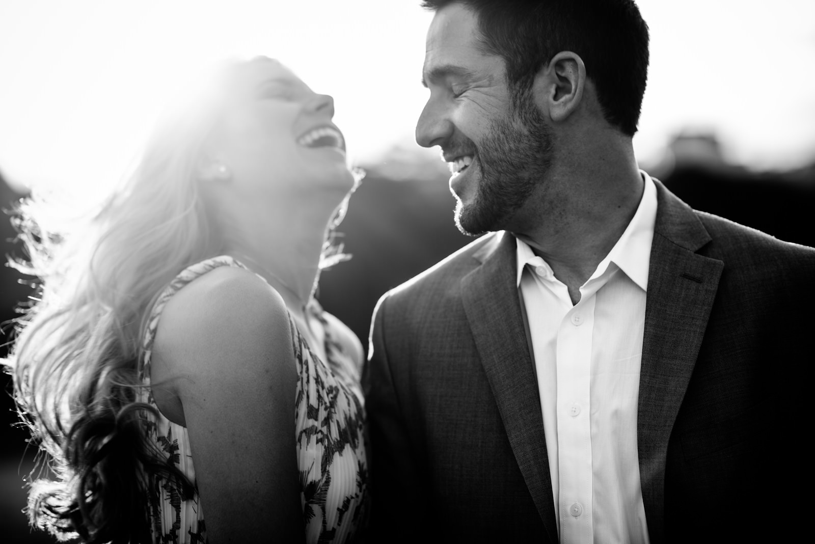 happy engaged couple laughing