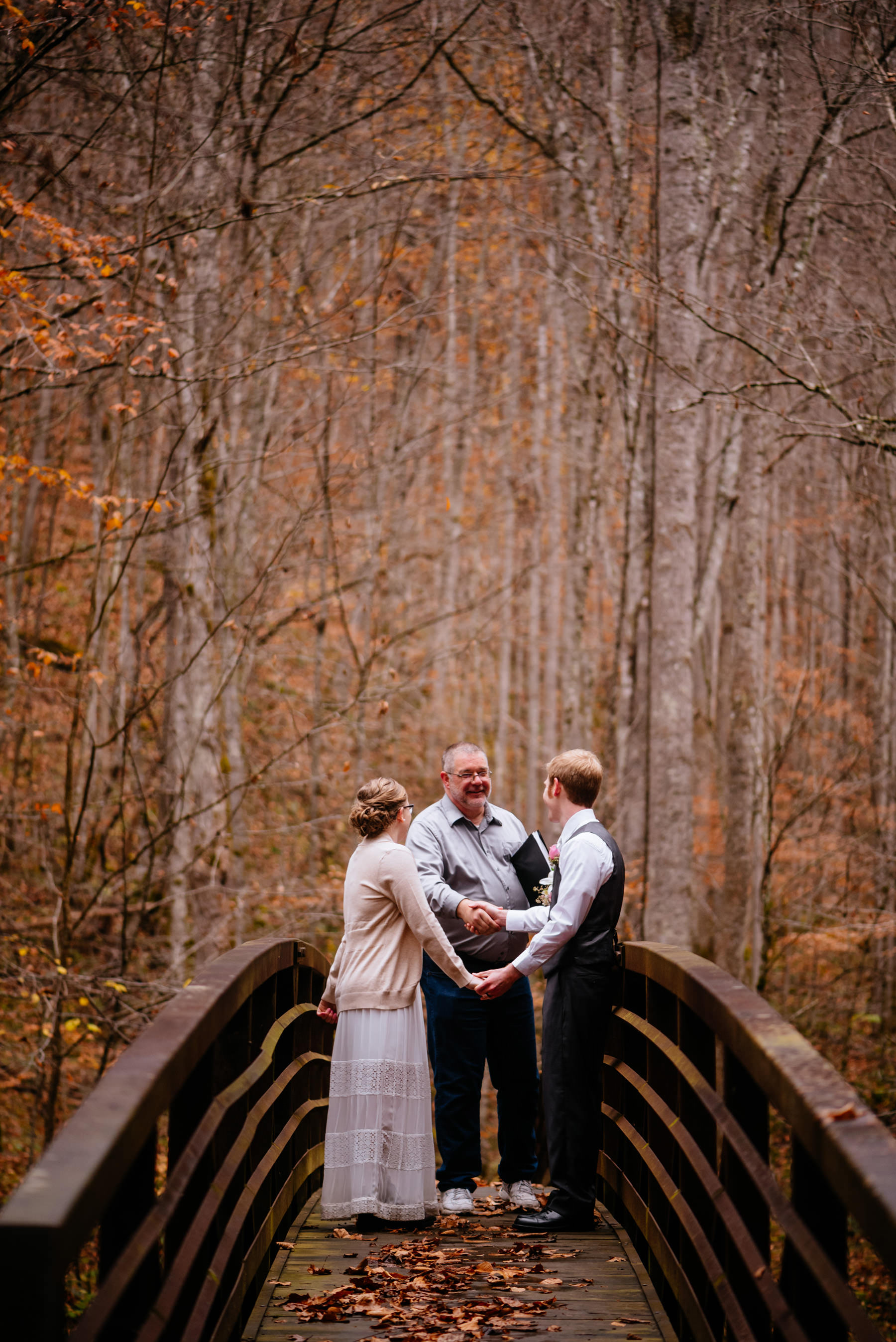 bride groom shaking hands with officiant wv autumn elopement