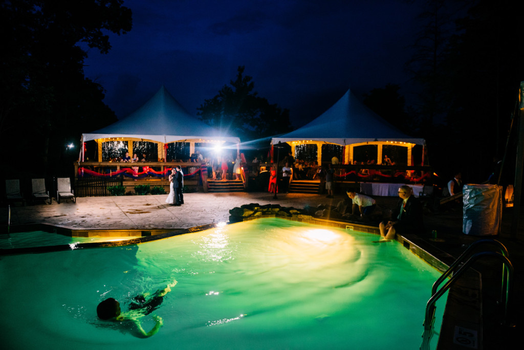 A guest takes a dip ni the pool while a bride and groom have their first dance at Adventures on the Gorge.