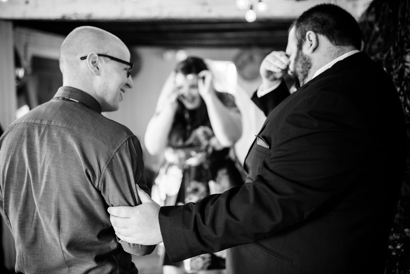 emotional brother in law with groom during ceremony in mushroom house terrain elopement