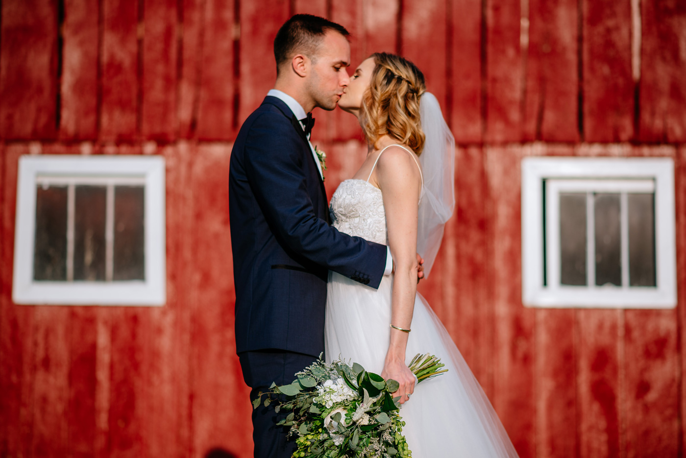 red barn bride and groom portrait