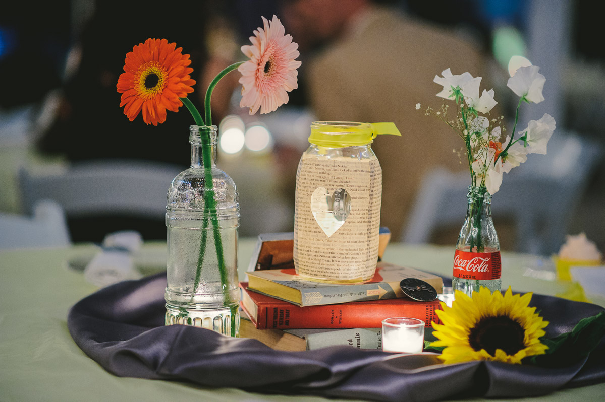 diy wedding table centerpiece detail with flowers bottles books