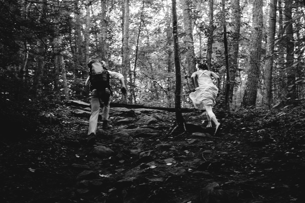 bride groom running through woods by best wv wedding photographers the oberports