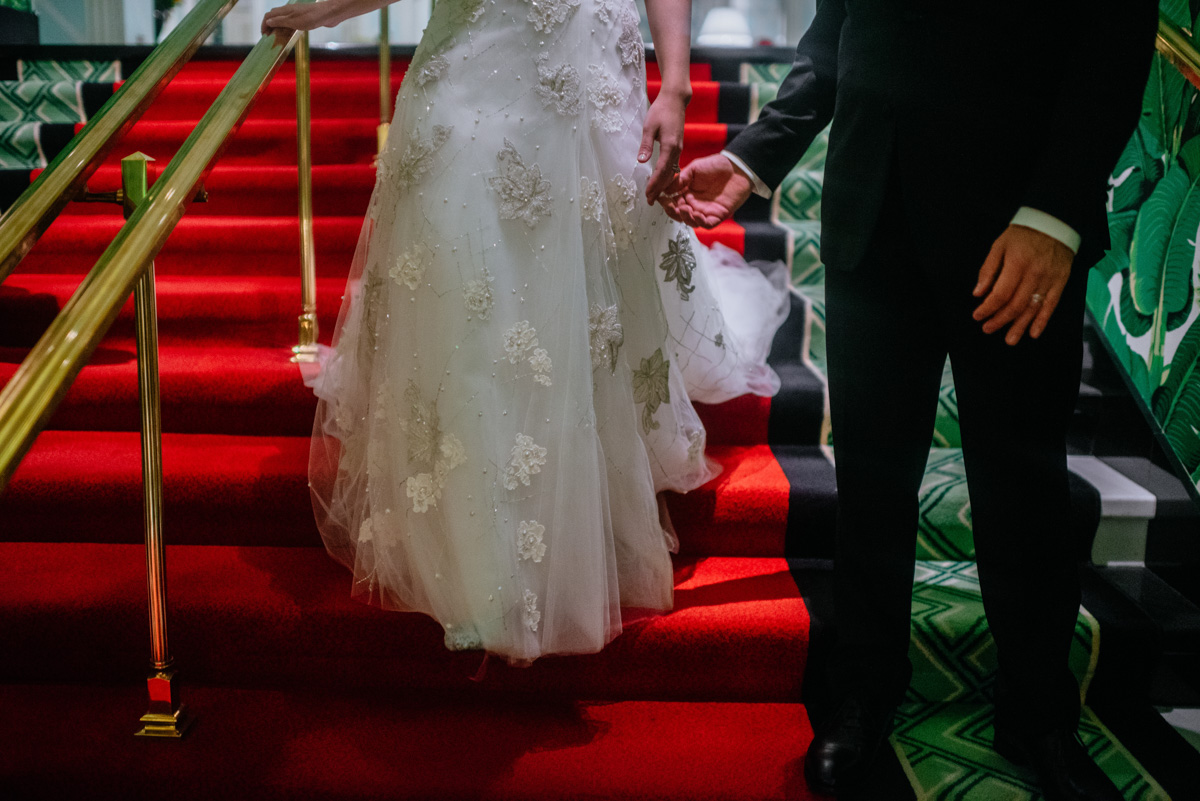 bride and groom walking down stairs at the greenbrier resort
