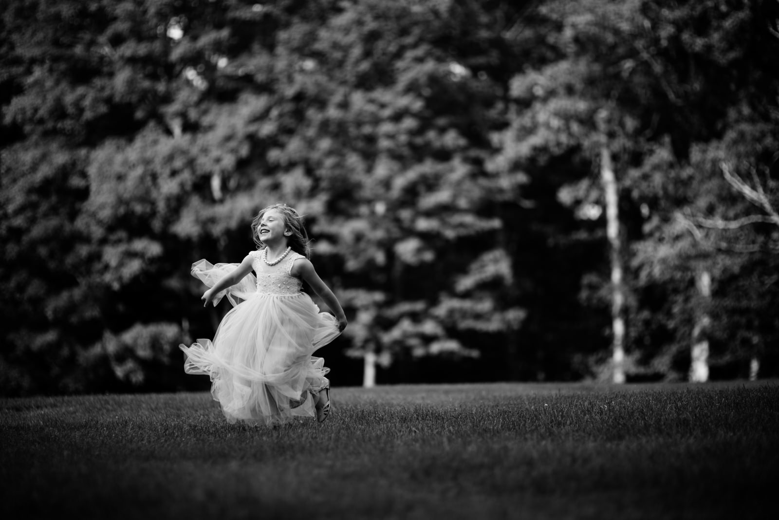 happy flower girl playing during wedding reception