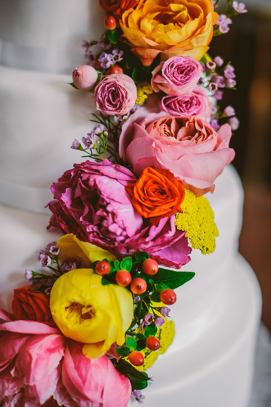 wedding cake with colorful cascading flowers1