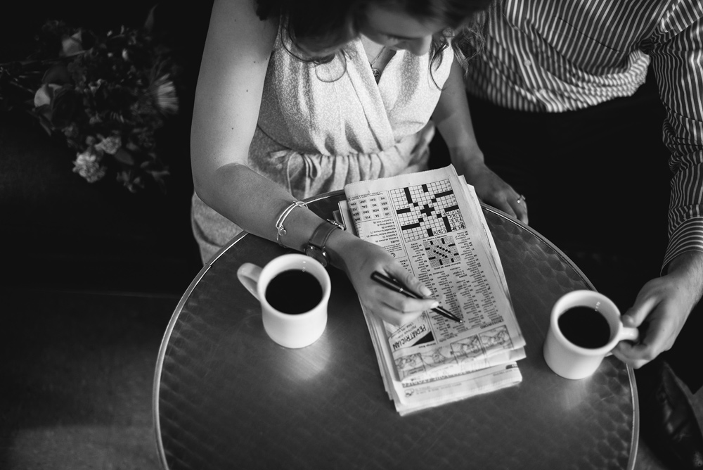 Couple works their way through a crossword puzzle over a cup of coffee at Taylor Books.