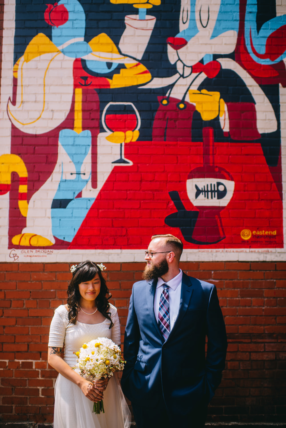 bride and groom in front of glen brogan mural chas wv