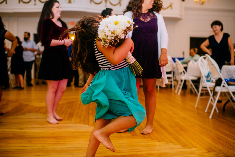 girl strutting with flowers after bouquet toss