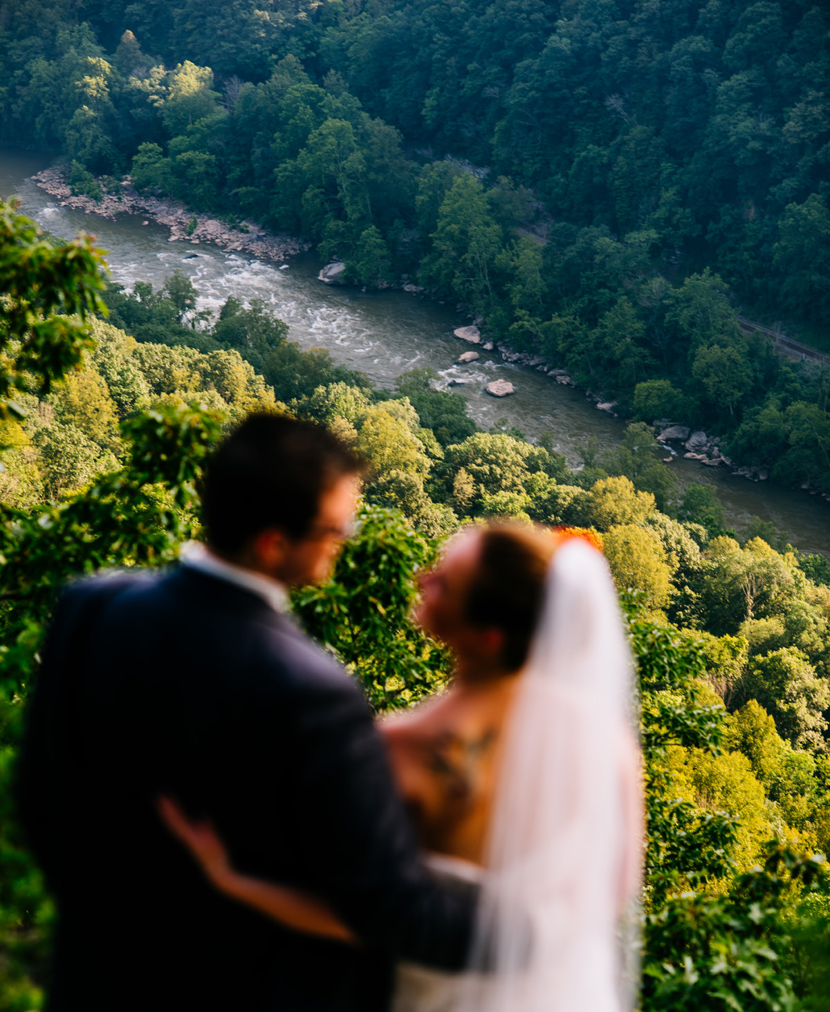 outdoorsy bride and groom who love rafting admire the new river