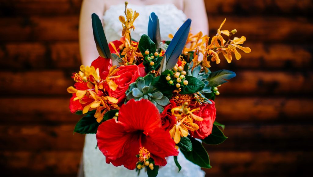tropical bridal bouquet with parrot feathers and hibiscus flowers