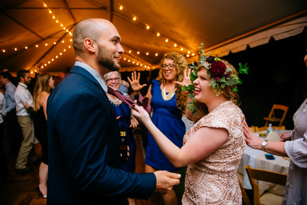 bride pulls grooms tie wedding reception benedict haid