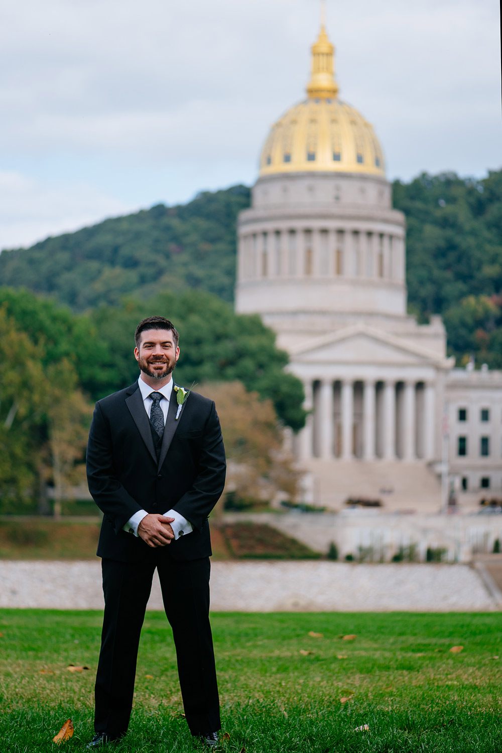 groom on the UC lawn with WV capitol in background