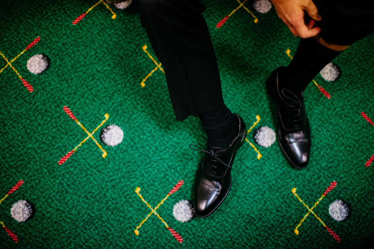 groom putting shoes on at the greenbrier sporting club
