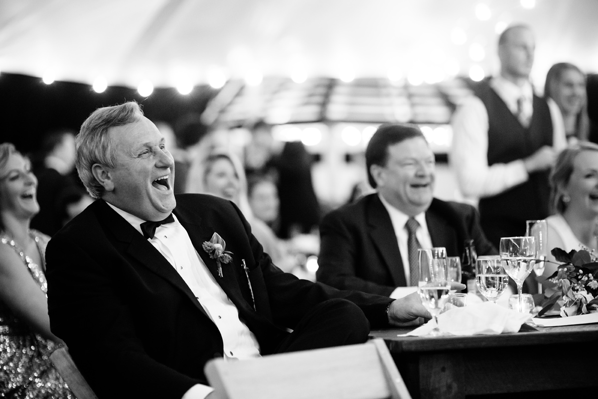 father of the bride laughs during toasts