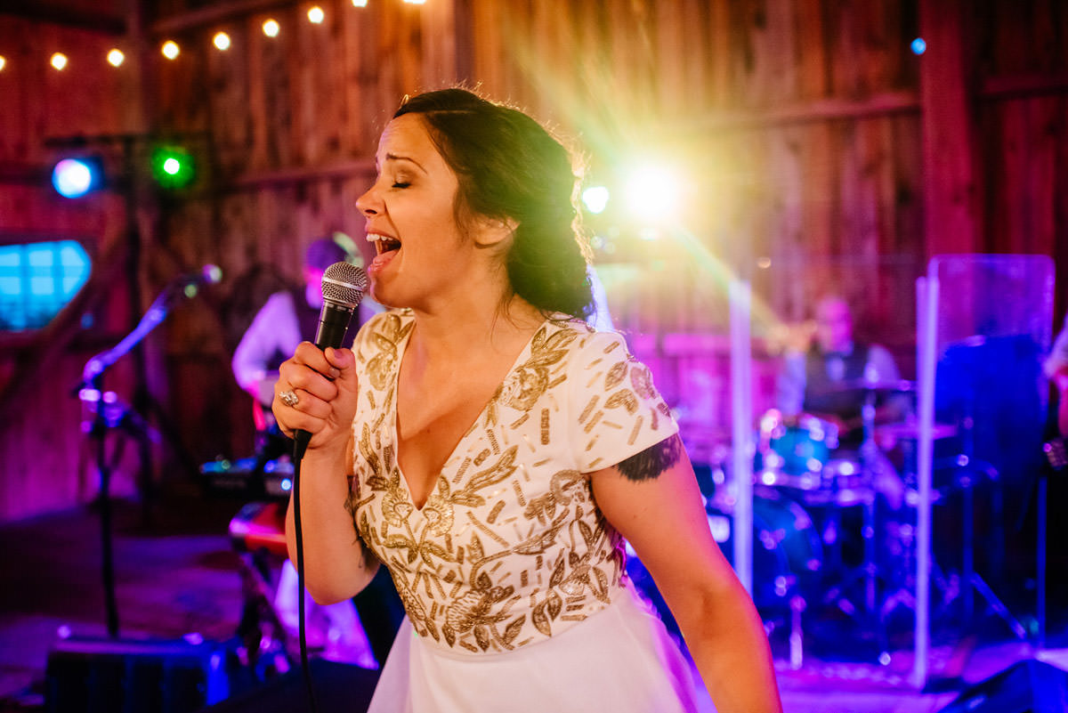rustic acres wedding reception bride sings for groom