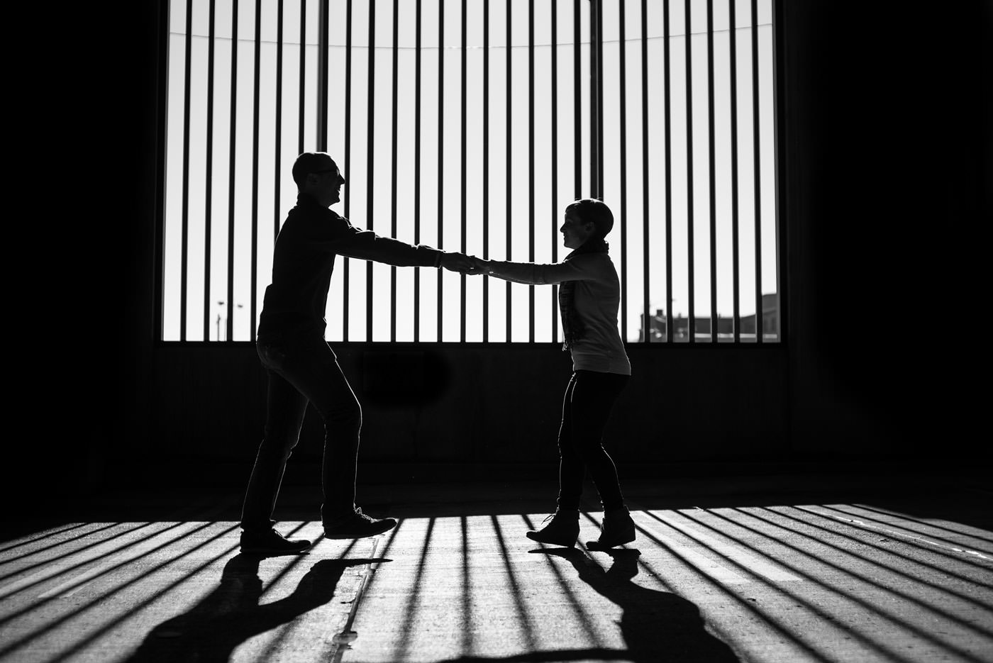 dancing in the shadows creative black and white engagement portrait