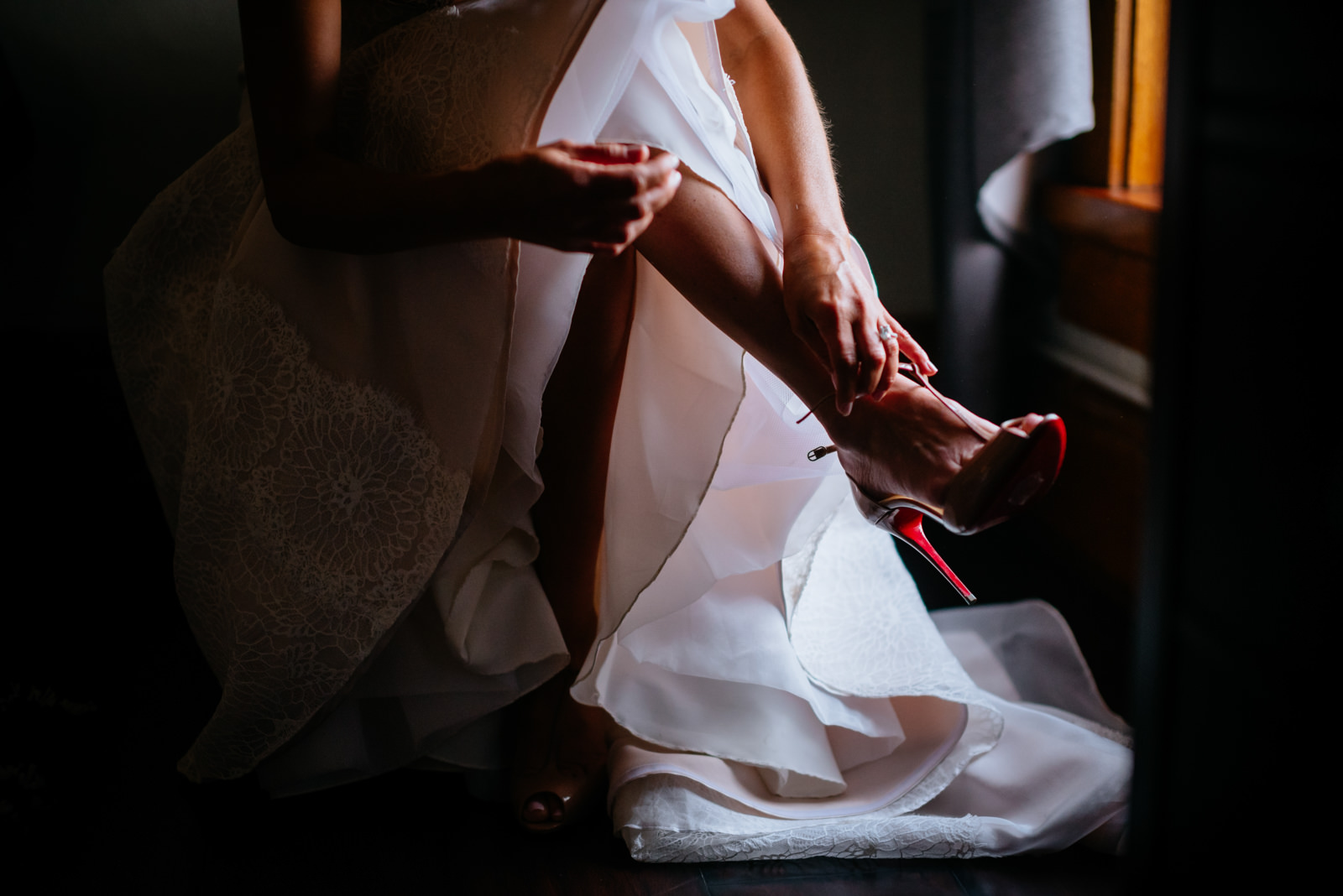 bride putting on louboutin shoes lafayette flats fayetteville wv wedding