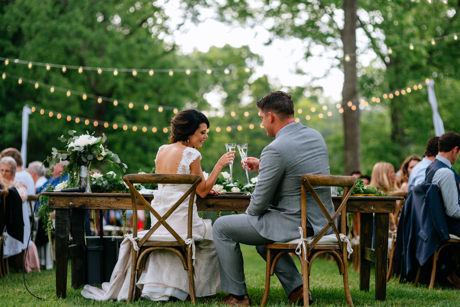 bride groom toasting during outdoor wedding reception