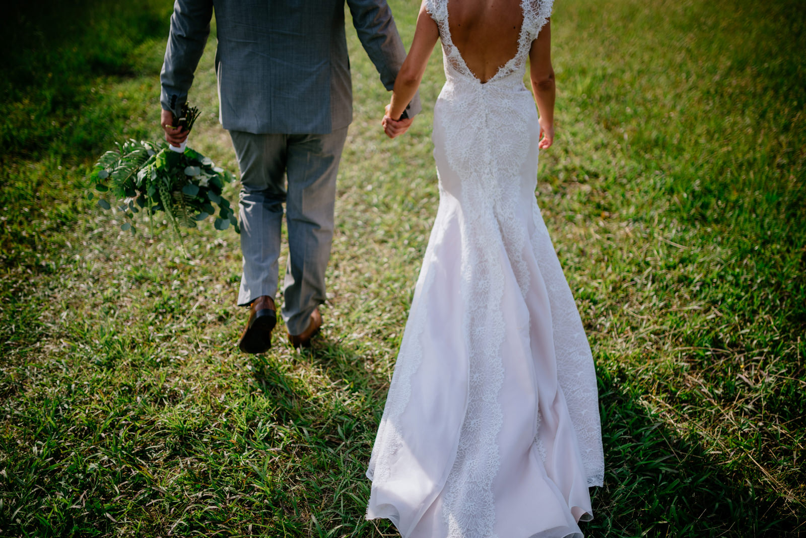 bride groom holding hands walking