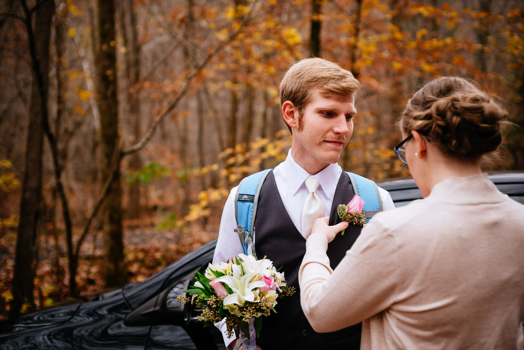 wv hiking elopement groom getting boutonniere