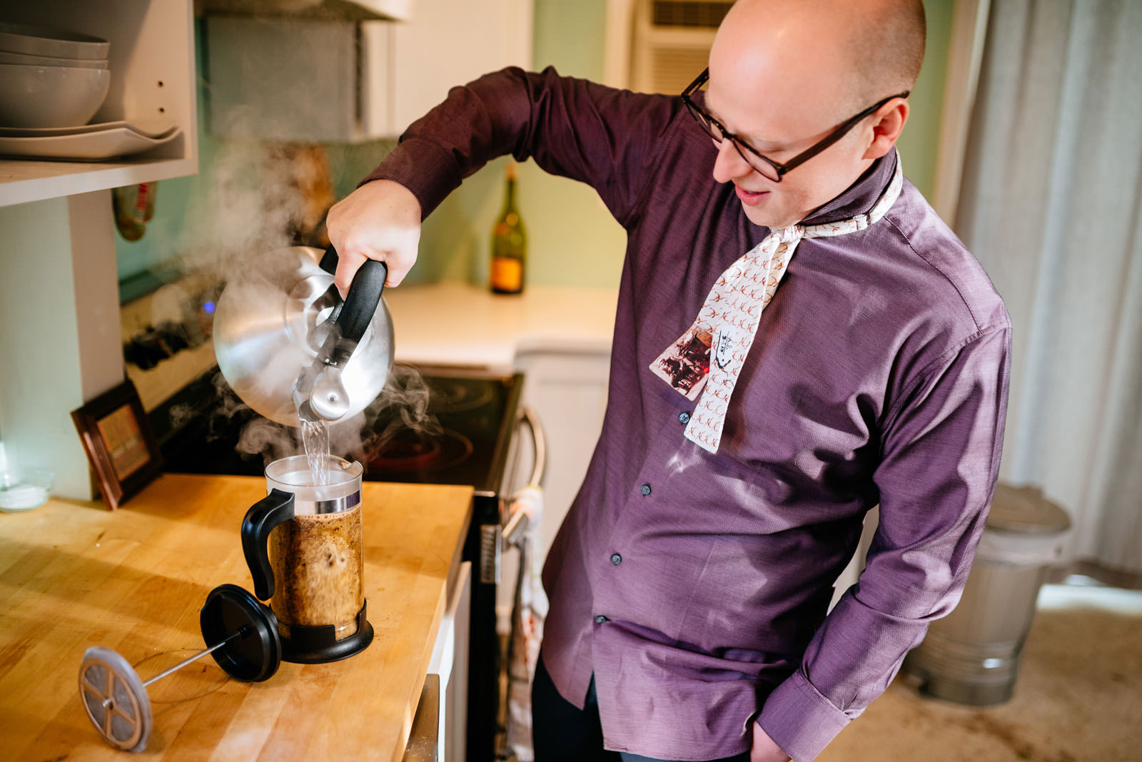 groom making french press coffee while getting ready philadelphia morning elopement