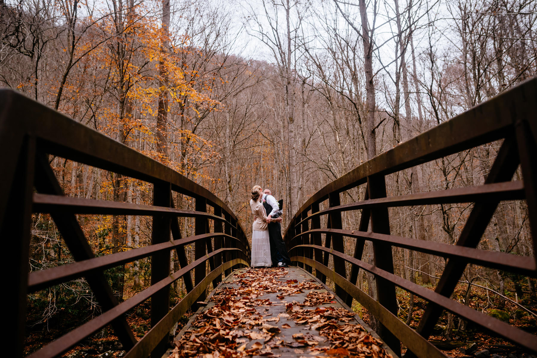 bride groom first kiss on bridge autumn wv hiking elopement