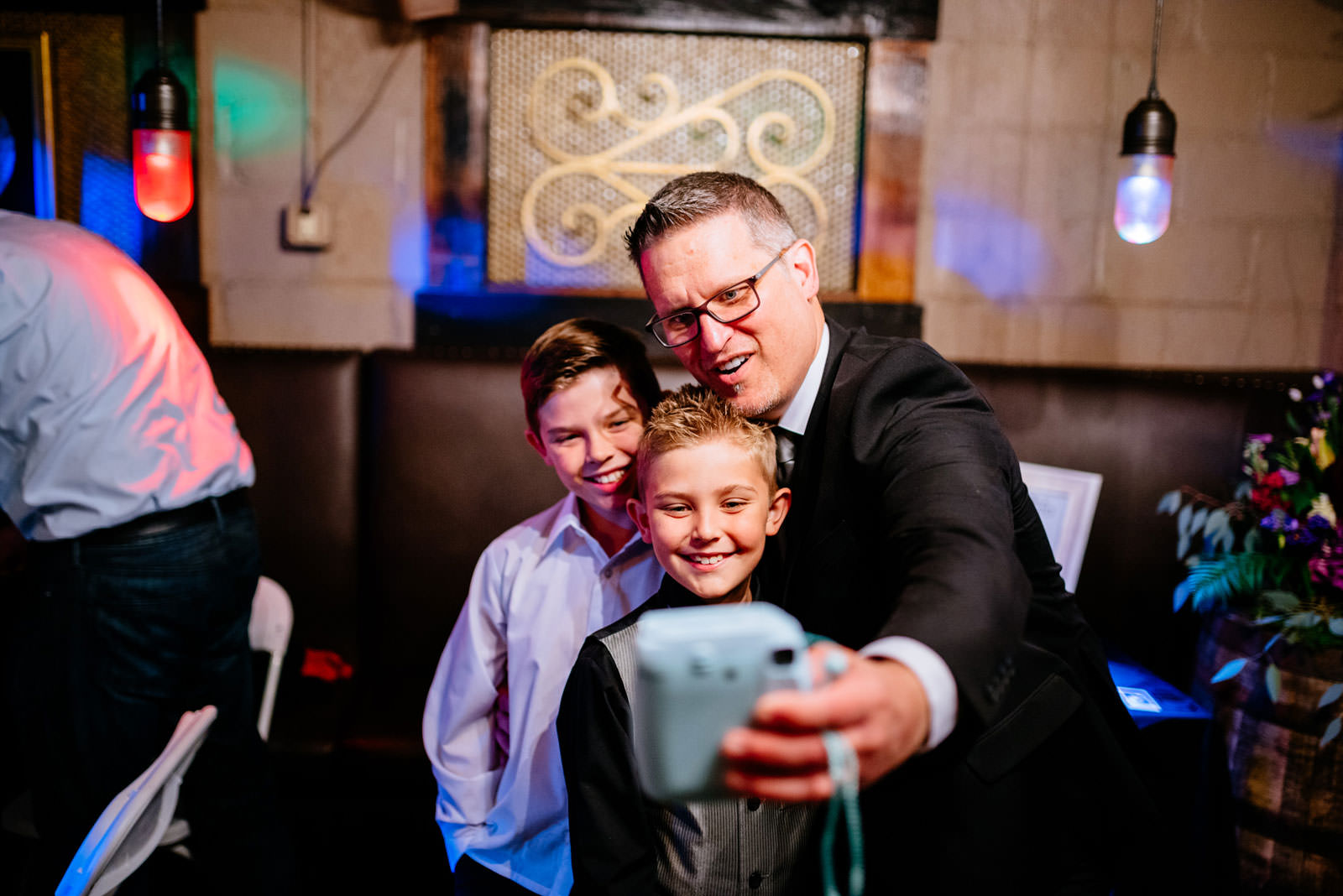 wedding guests using instax camera selfie