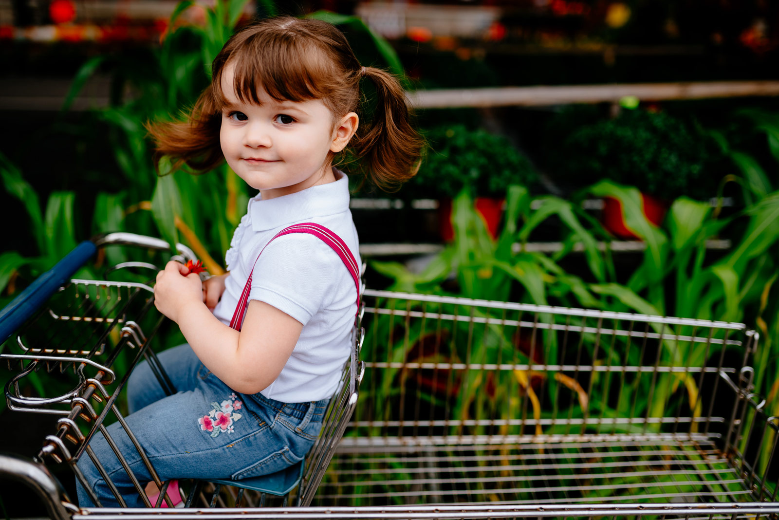 Happy little girl sitting in a shopping cart at the Capitol Market in Charleston, WV.