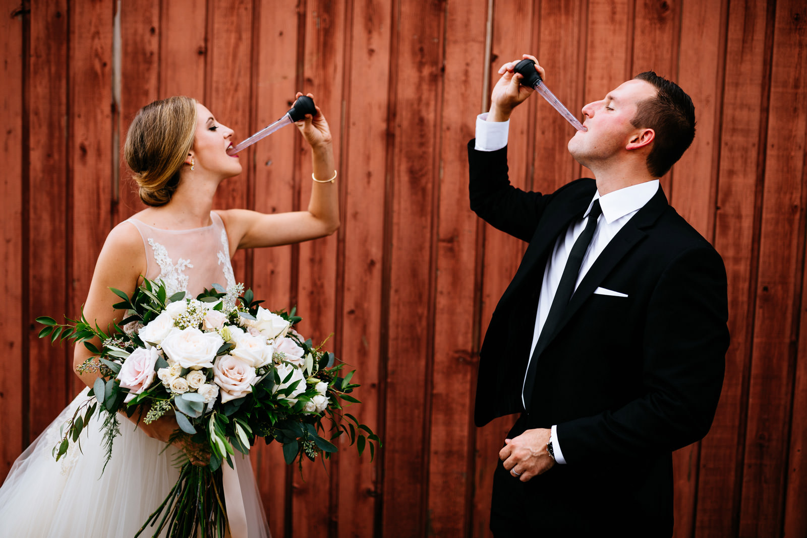 bride groom take gin bucket shots zenner house wedding athens ohio