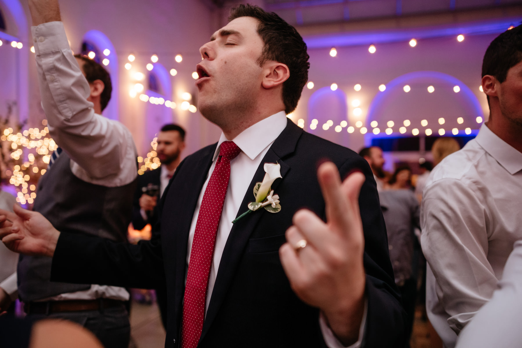 groom singing during wedding reception