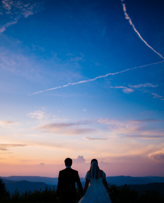 A silhouette of a couple against a twilight sky.