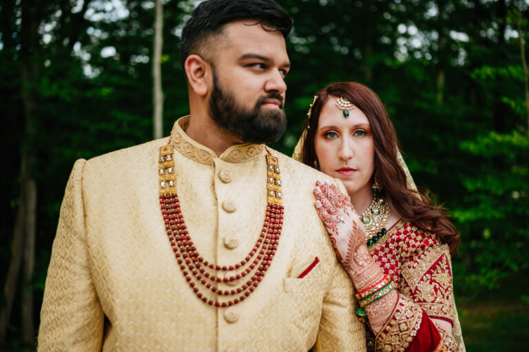 Meghan and Aikansh standing amongst the trees.