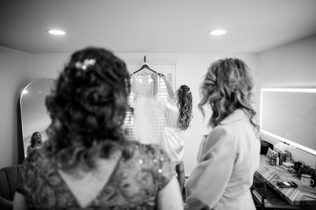 bride takes dress off hanger at batten green wedding