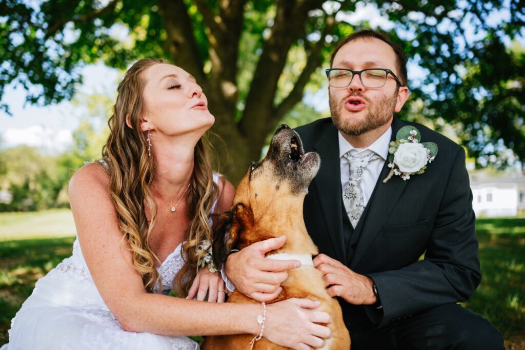 bride and groom howling with their dog