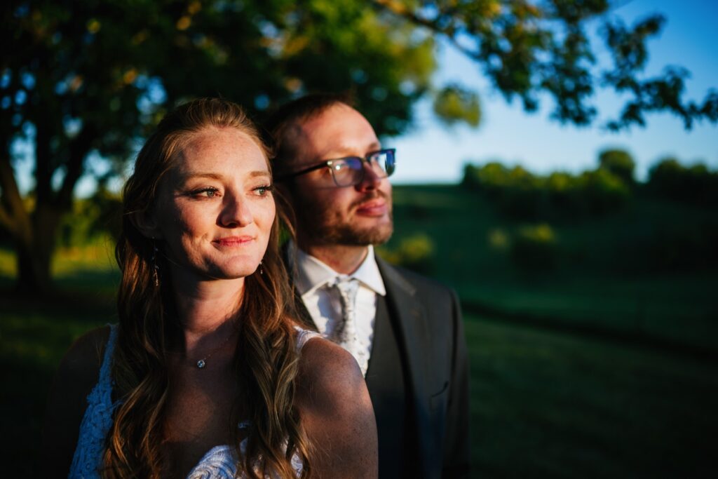 bride and groom shar ea quiet moment in the sun at their batten green wedding