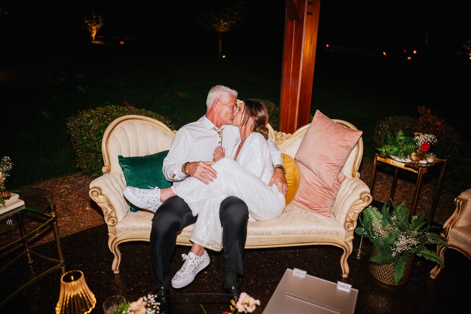 The bride and groom sharing a smooch on their couch at this Wilderness Lodge Summersville WV wedding.