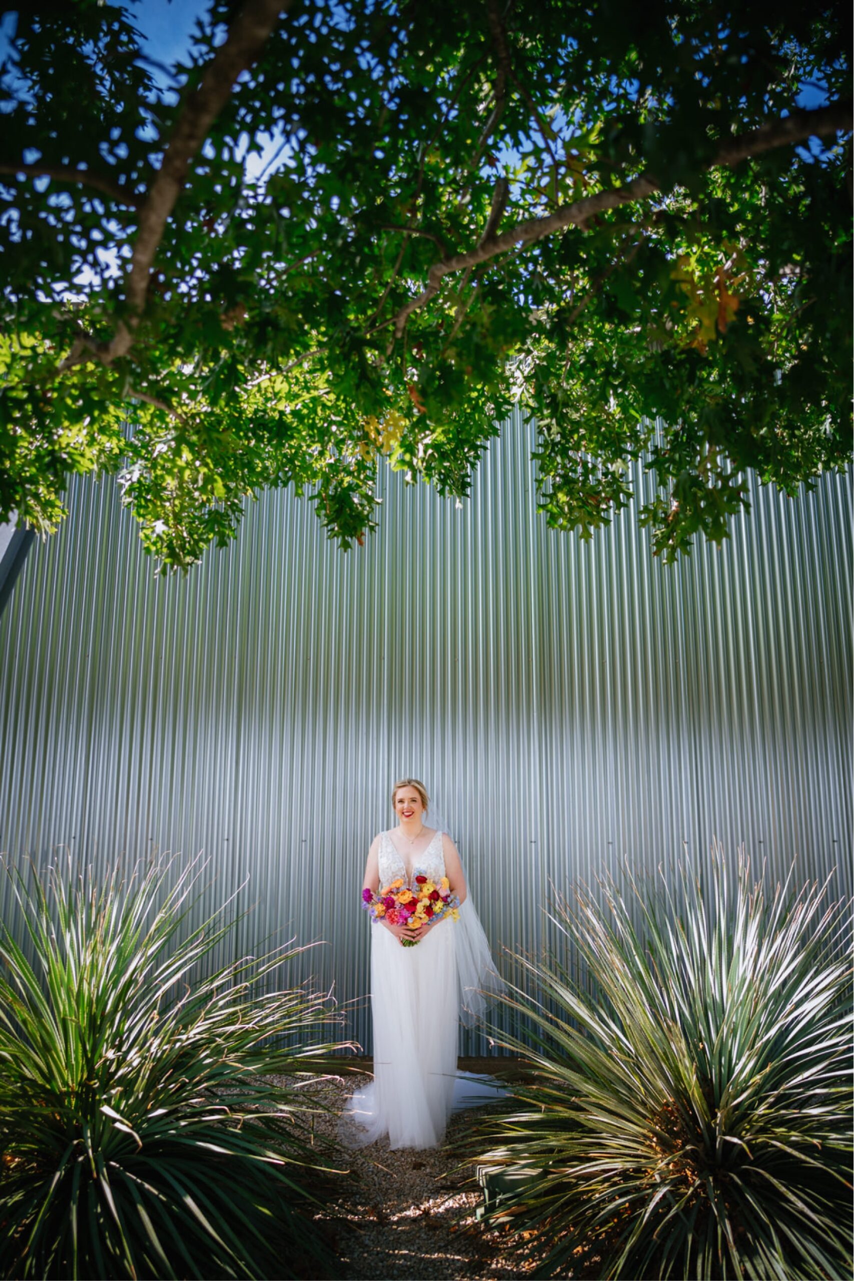 Bride in front of steel walls at Prospect House Austin TX wedding